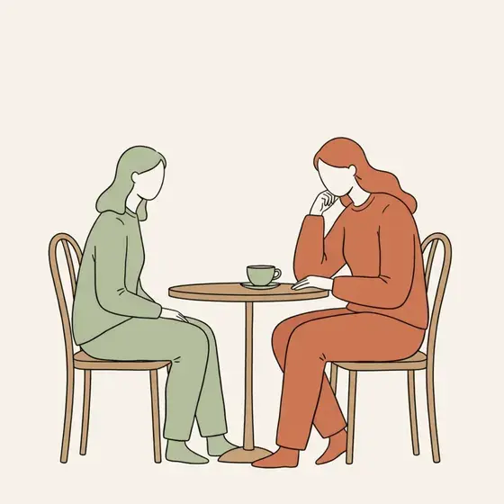 Two figures at a small café table, one watching the other from the inside